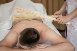 Japanese massage with bamboo brooms, drainage massage.