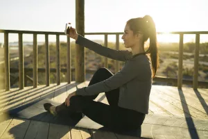 A Young Woman Devotedly Practicing SelfCare Amidst the Beauty of a Peaceful Sunrise