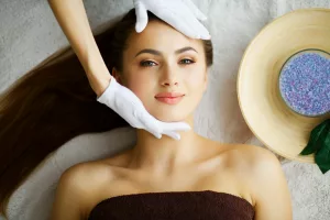 Beauty and Care. Young Woman Lying On Massage Tables In Spa Salo