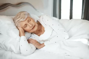 Quality sleep, quality life. Shot of a senior woman sleeping in bed in a nursing home.