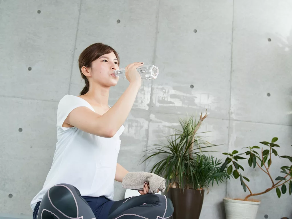 Japanese woman hydrating during training