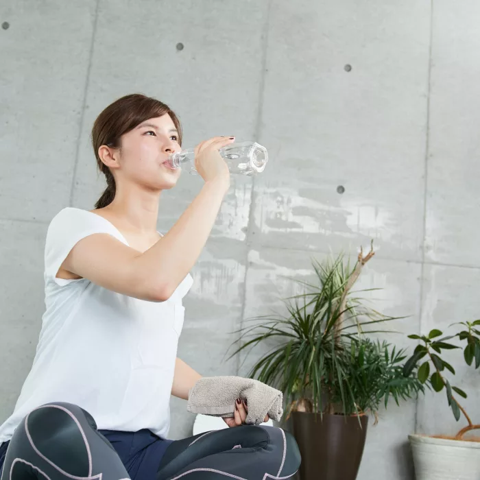 Japanese woman hydrating during training