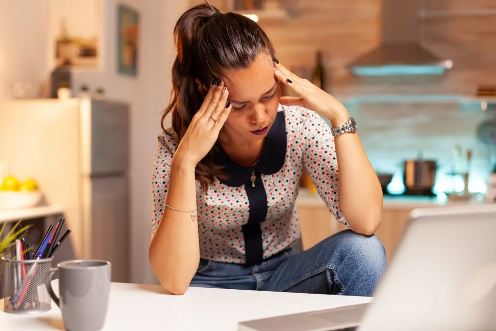 Stressed woman working overtime